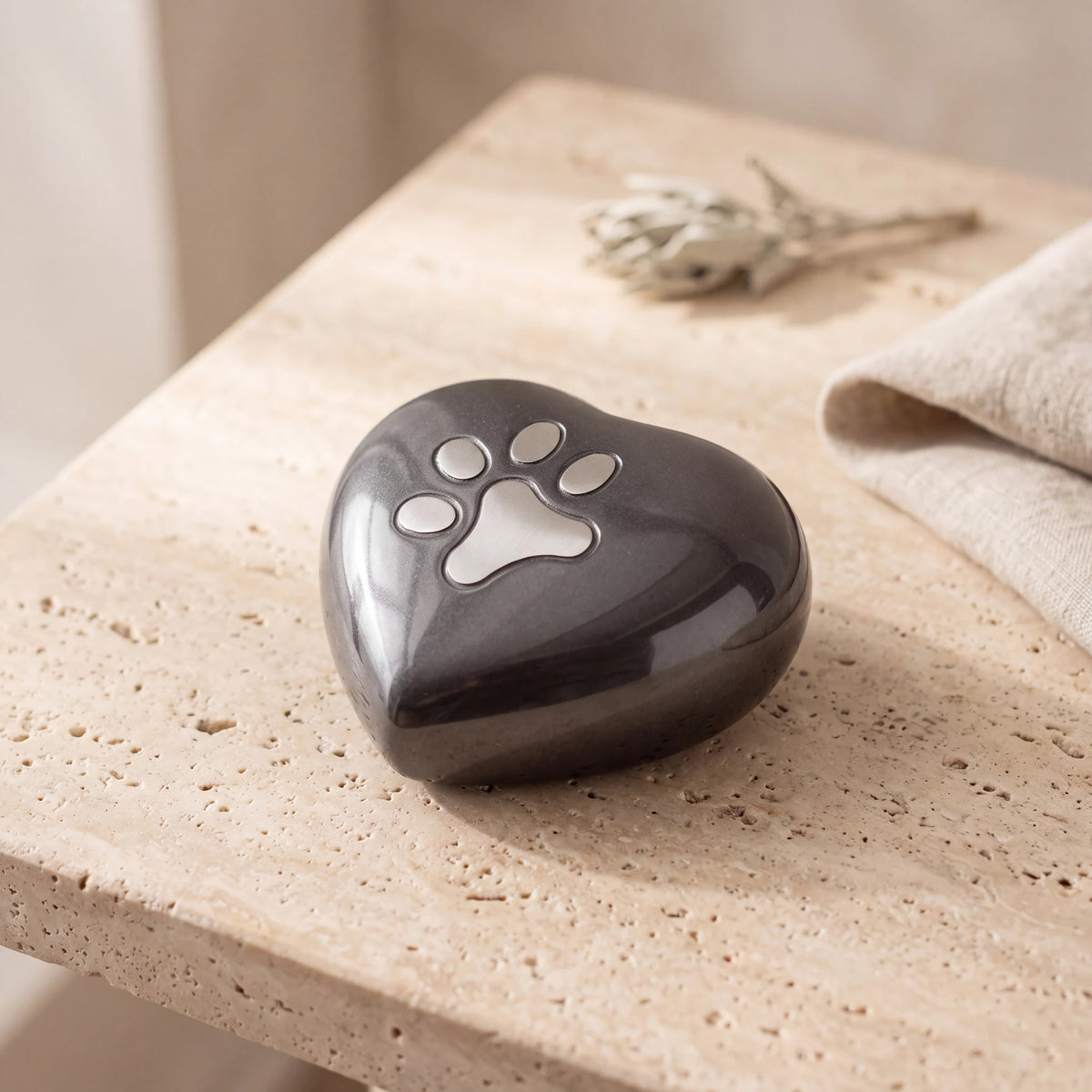 Pawprint-Heart-Pet-Urn-for-Ashes-in-Graphite-Silver-Small-On-Travertine