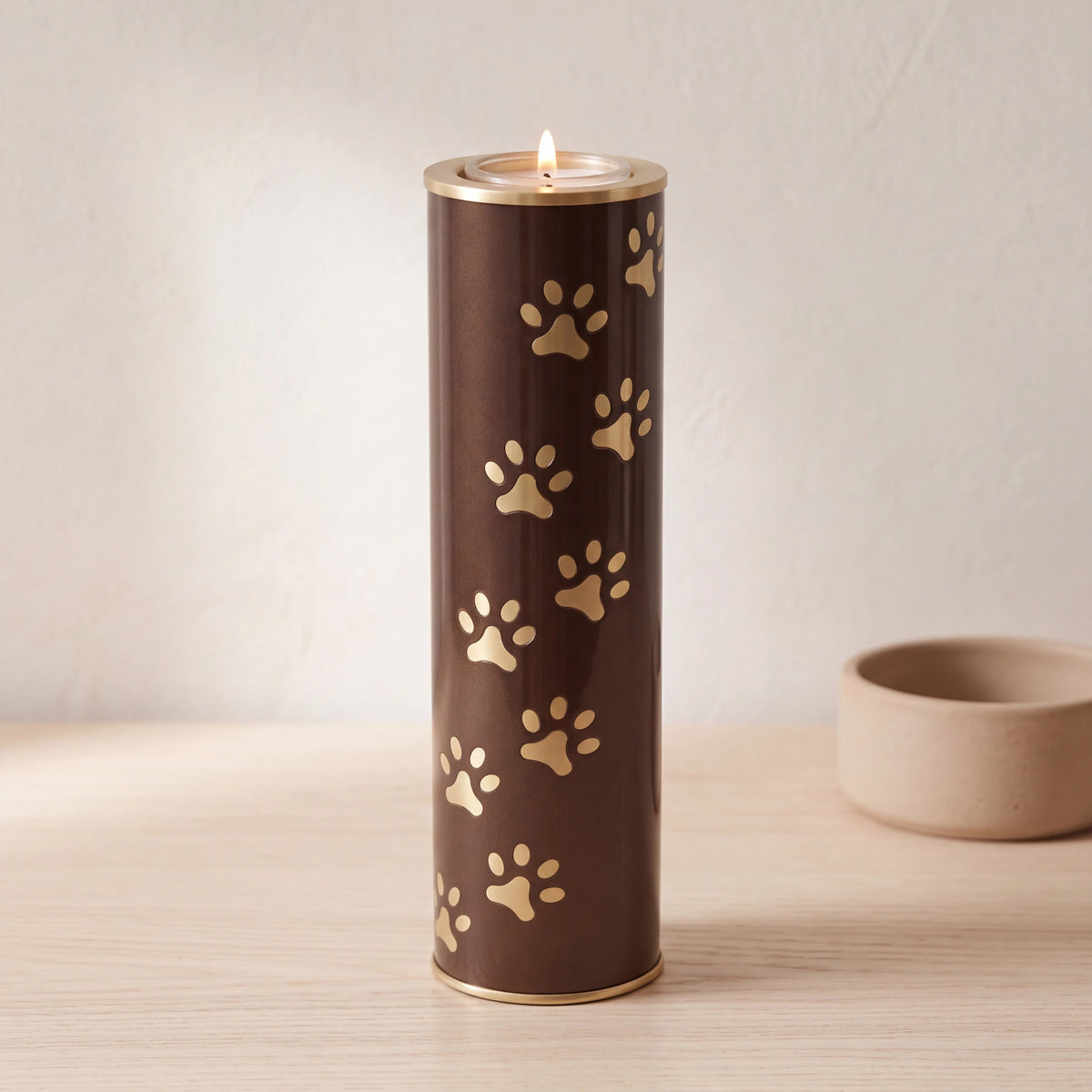 Pawprints-Candle-Pet-Urn-for-Ashes-in-Brown-and-Gold-Large-pet_bowl_ledge