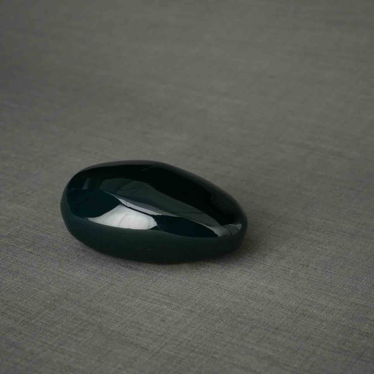 Pebbles Ashes Keepsake Urn in Dark Green Facing Right Dark Background