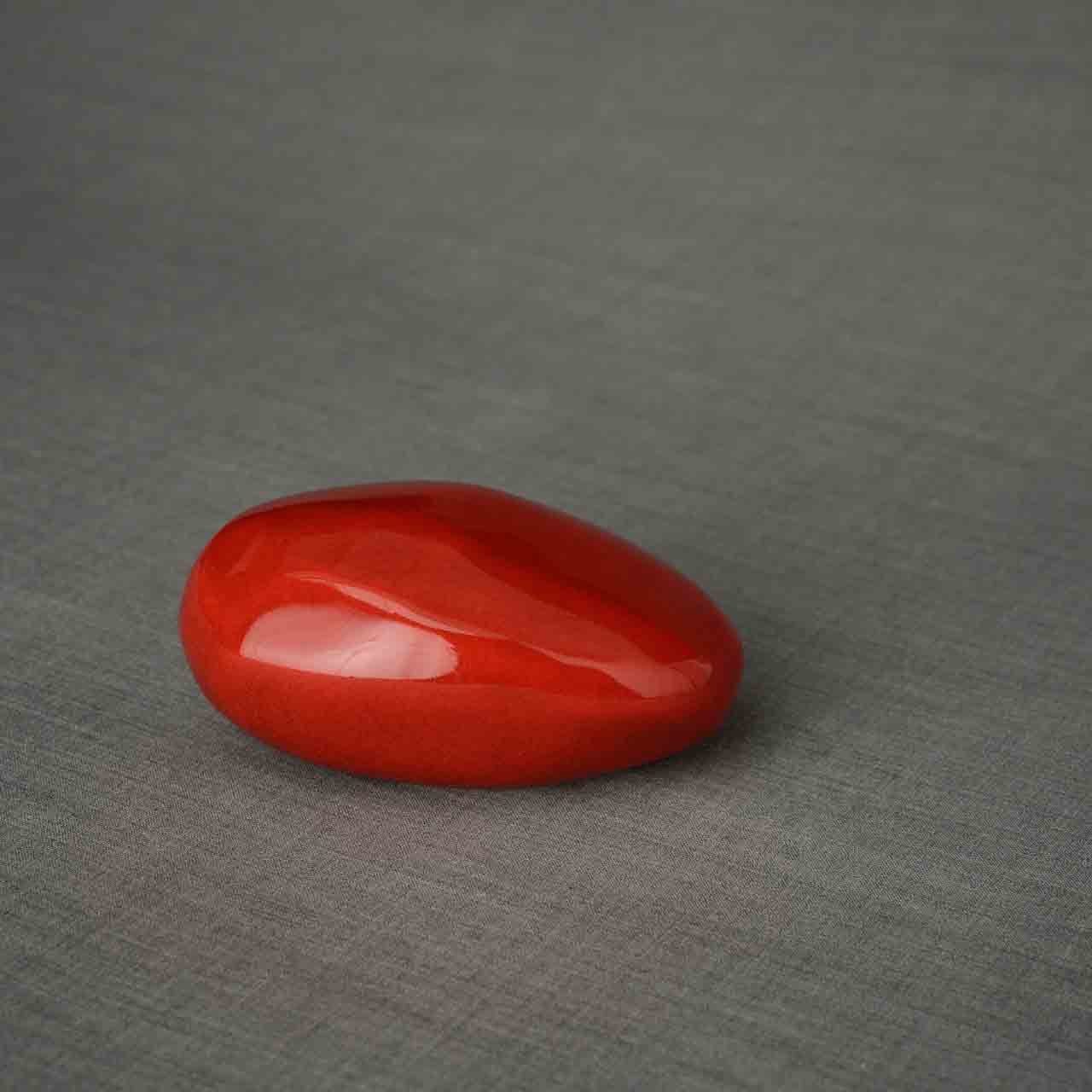 Pebbles Ashes Keepsake Urn in Red Facing Right Dark Background