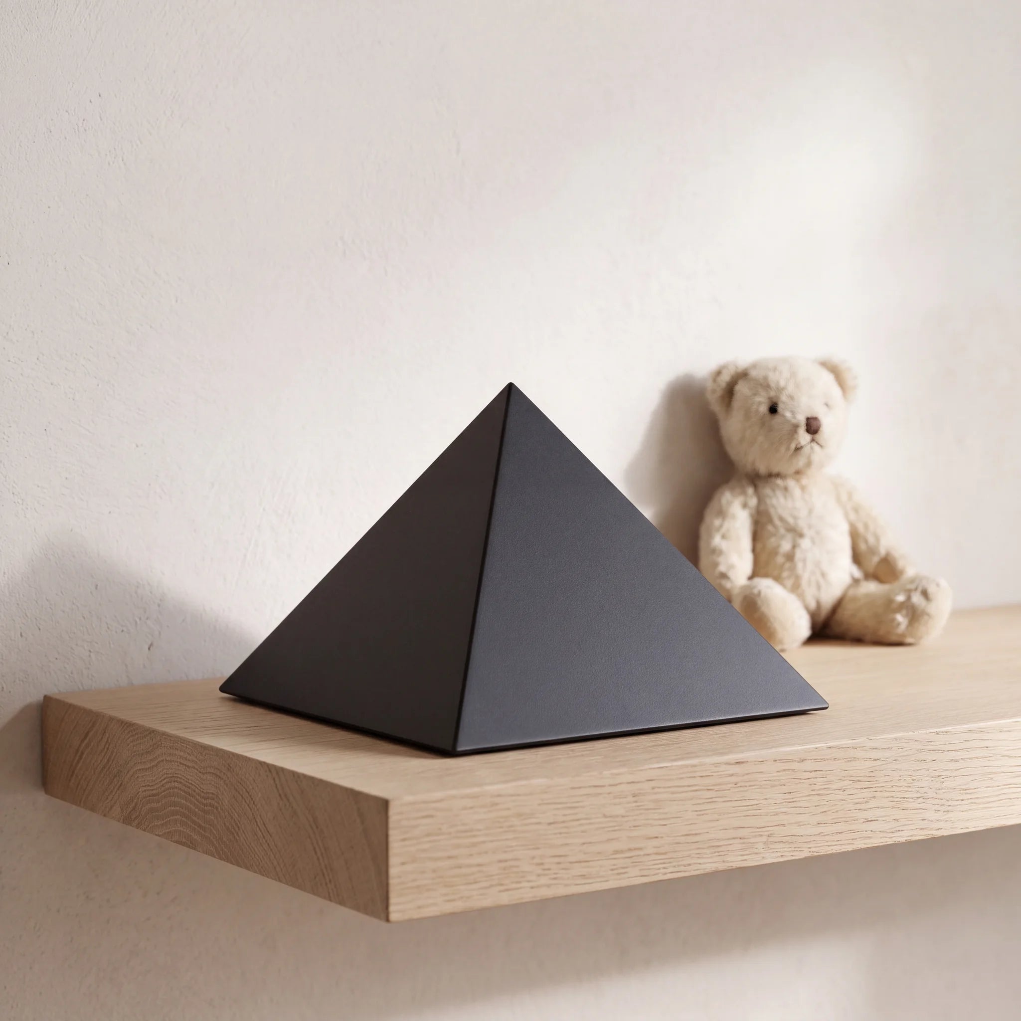 Pyramid-Pet-Urn-for-Ashes-in-Matte-Black-Stainless-Steel-pet_soft_toy_shelf