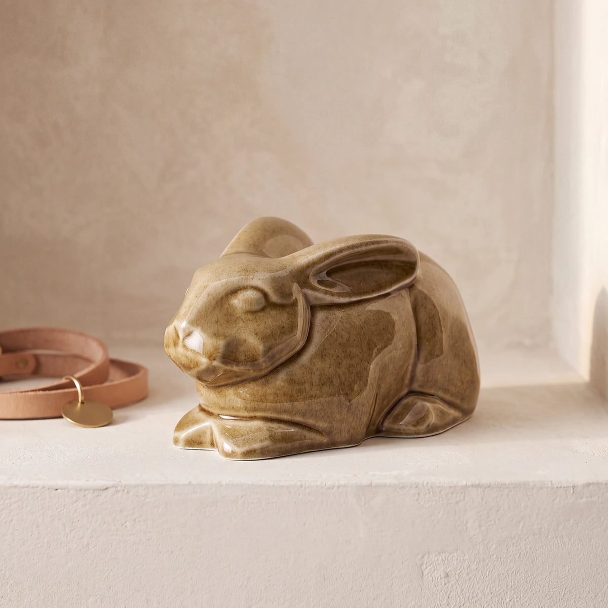 Rabbit-Urn-for-Ashes-in-Dark-Sand-pet_collar_ledge