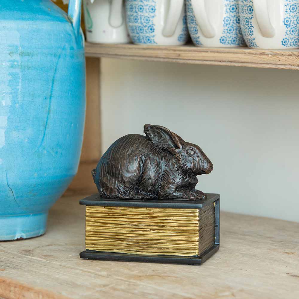 Rabbit on Boock Urn for Ashes on Shelf