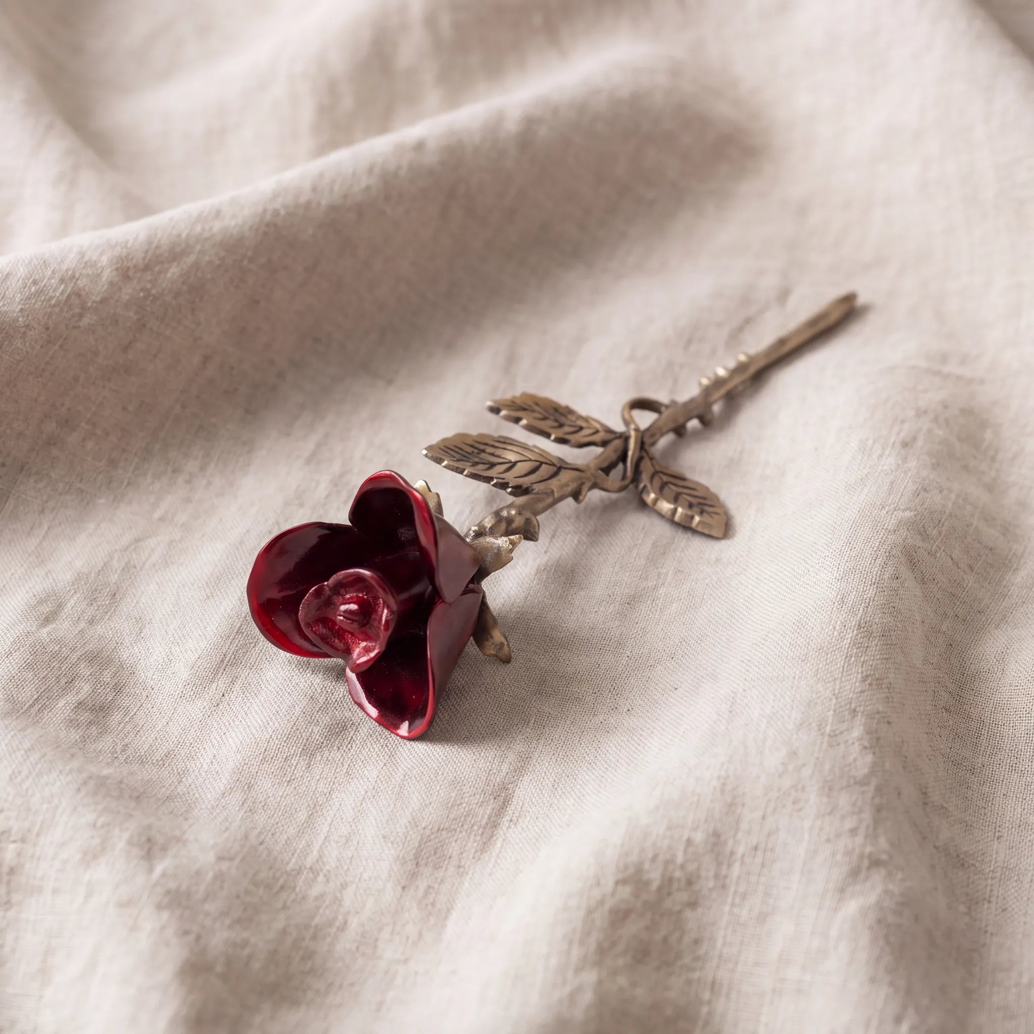 Rose-Keepsake-Urn-for-Ashes-in-Red-and-Bronze-On-Linen