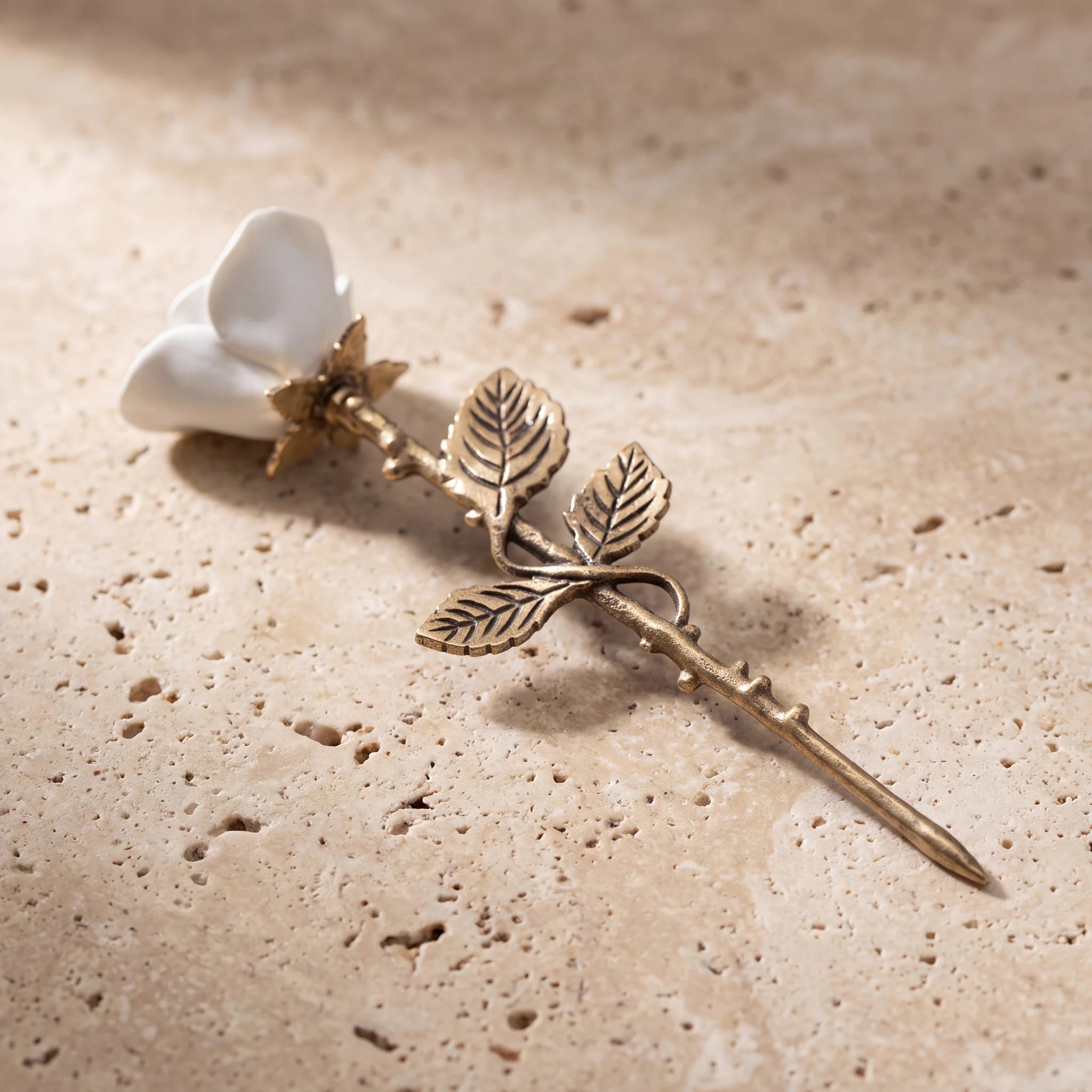 Rose-Keepsake-Urn-for-Ashes-in-White-and-Bronze-On-Travertine