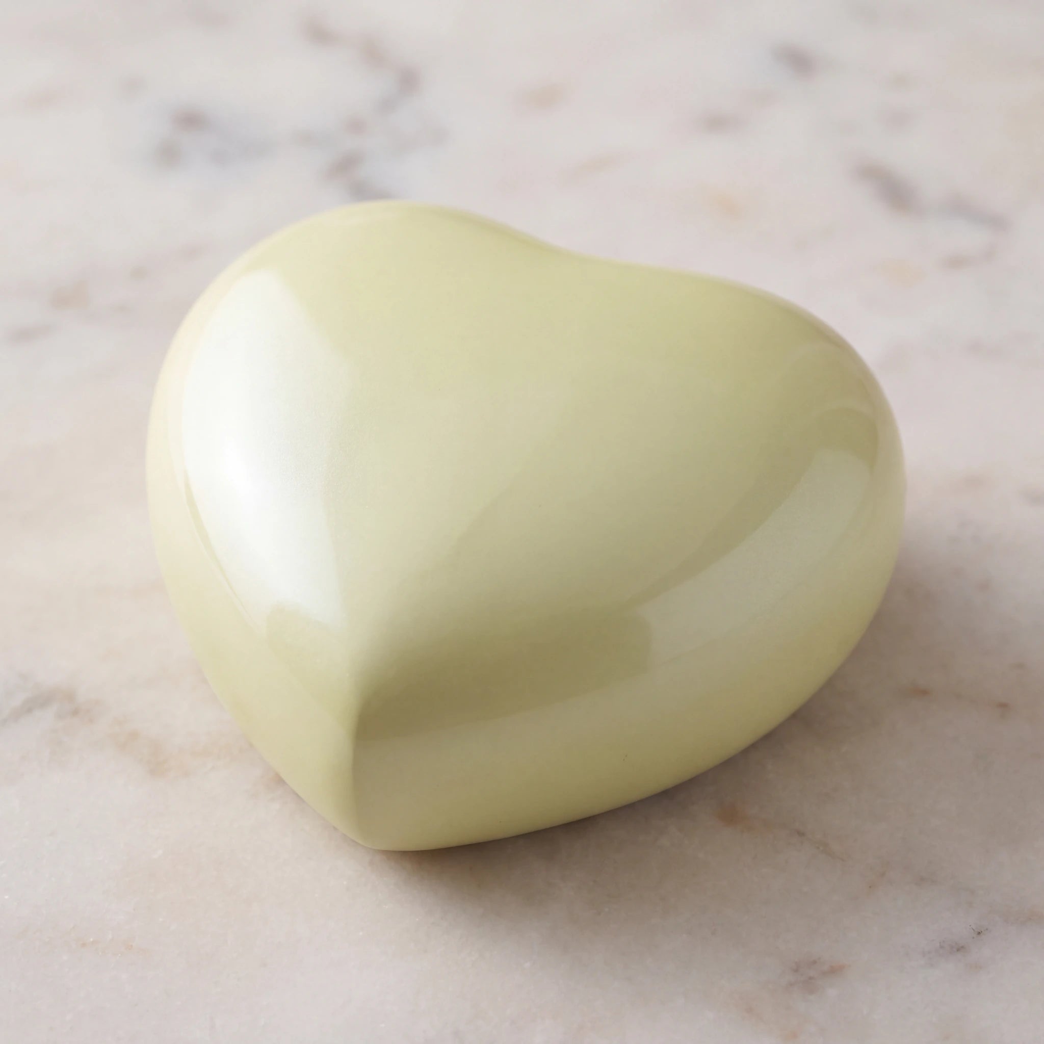 Satori-Metal-Heart-Keepsake-Urn-for-Ashes-in-Pearl-Yellow-On-Marble