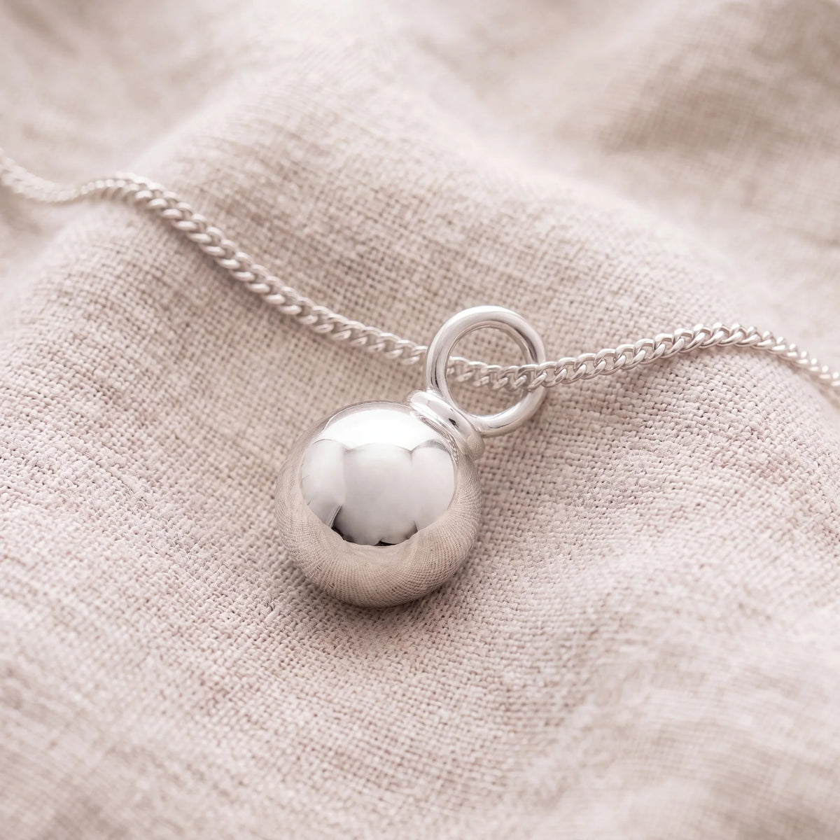 Self-fill-Ball-Memorial-Ashes-Pendant-On-Linen