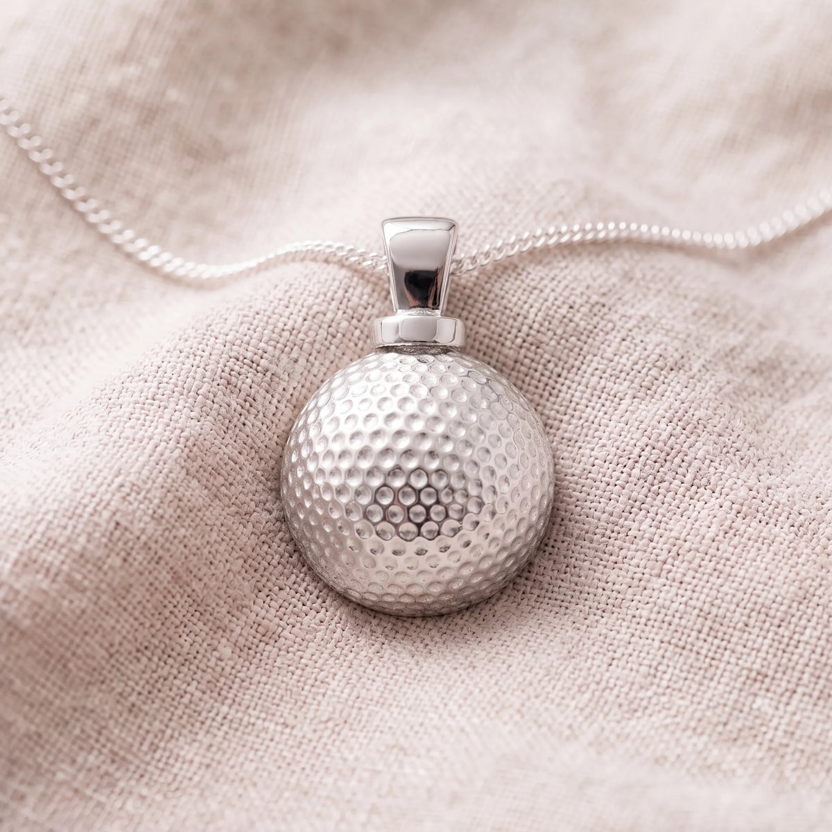 Self-fill-Golf-Ball-Memorial-Ashes-Pendant-On-Linen