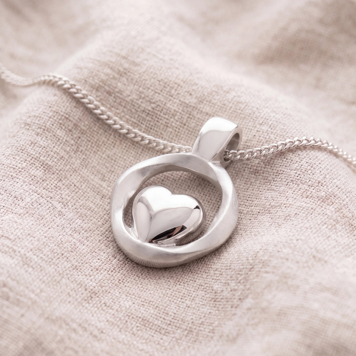 Self-fill-Heart-Embrace-Memorial-Ashes-Pendant-On-Linen