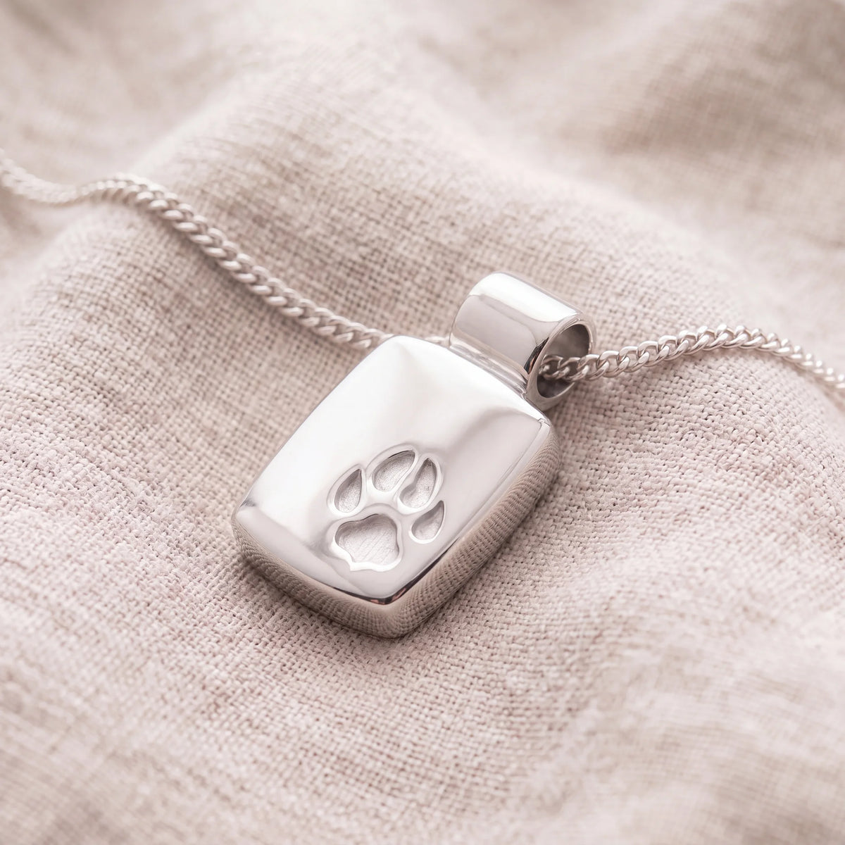Self-fill-Paw-Memorial-Ashes-Pendant-On-Linen