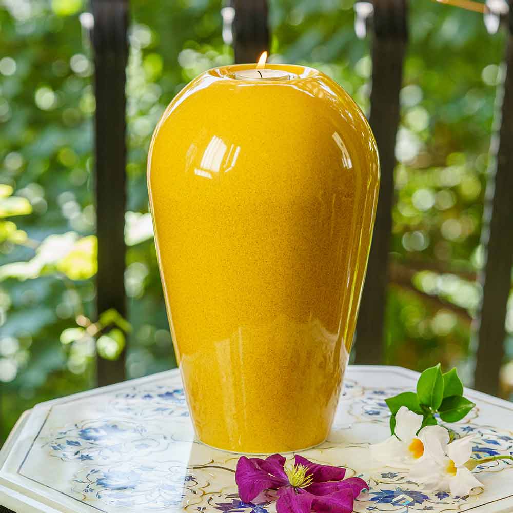 Serenity Adult Cremation Urn for Ashes in Amber Yellow Outside on Table