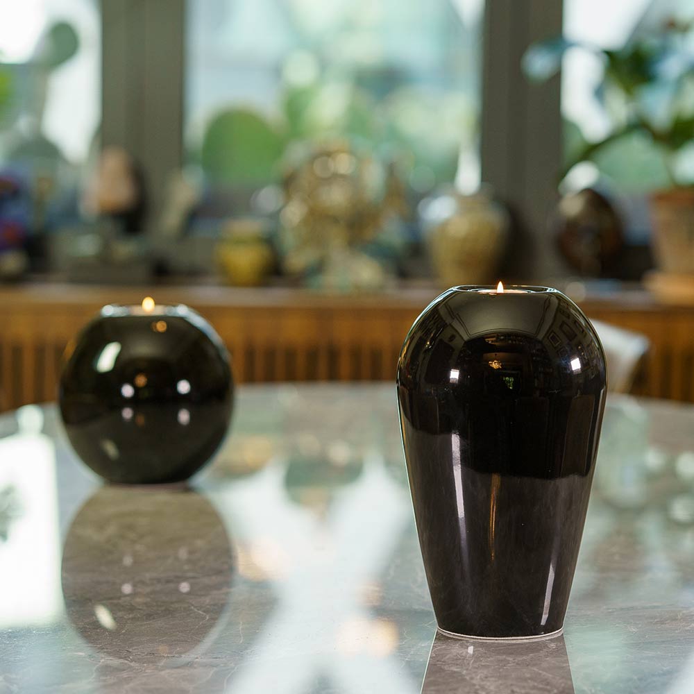 Serenity Adult Cremation Urn for Ashes in Glossy Black on Reflective Table