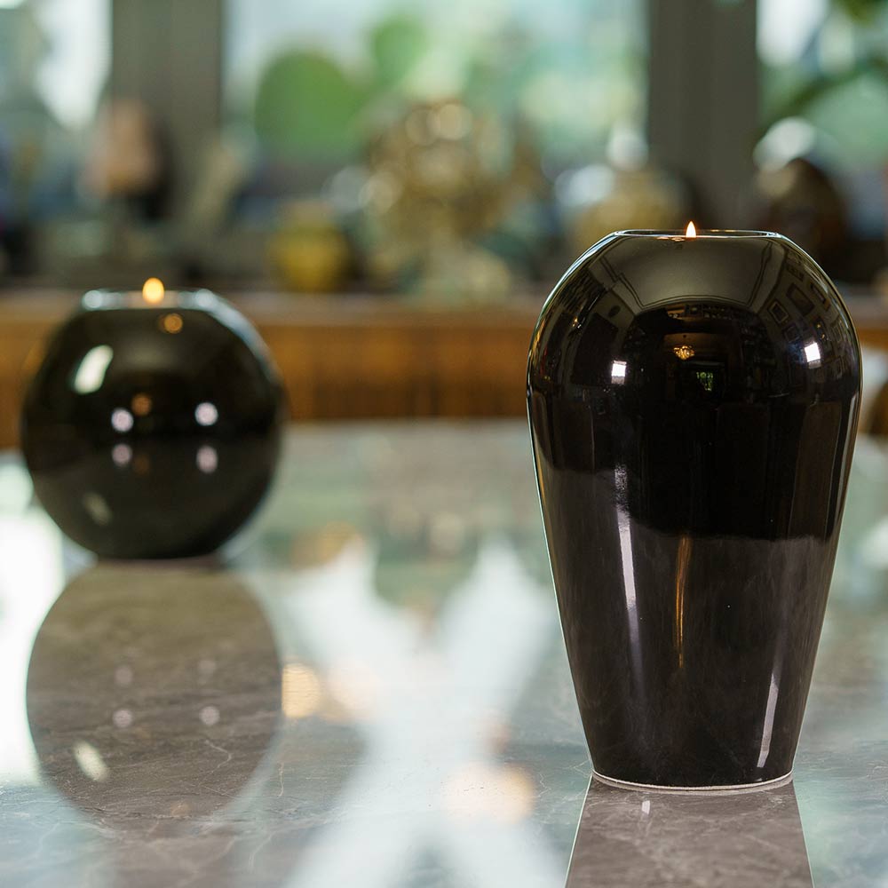 Serenity Adult Cremation Urn for Ashes in Glossy Black on Table