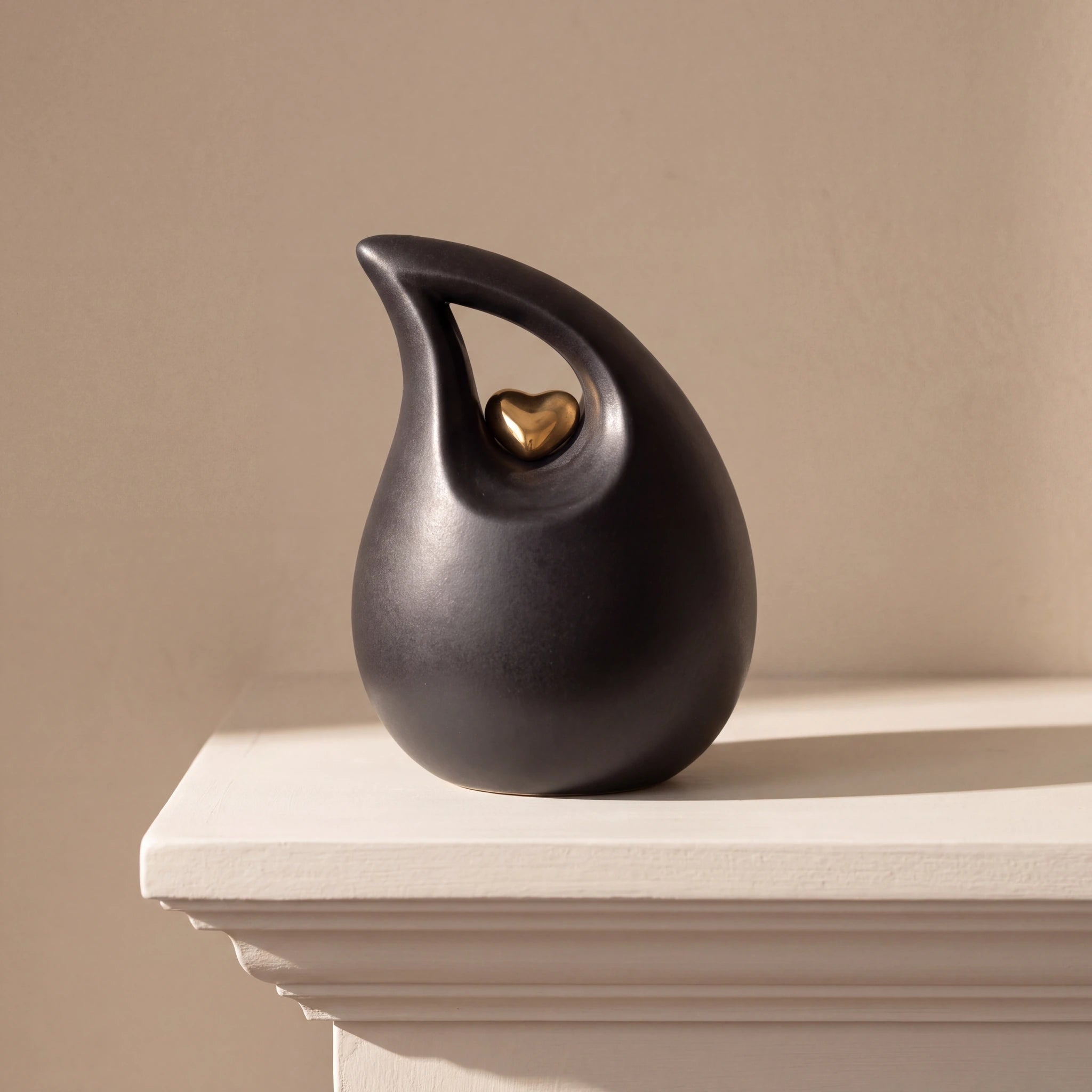 Teardrop-Heart-Small-Urn-for-Ashes-in-Black-and-Gold-Mantelpiece