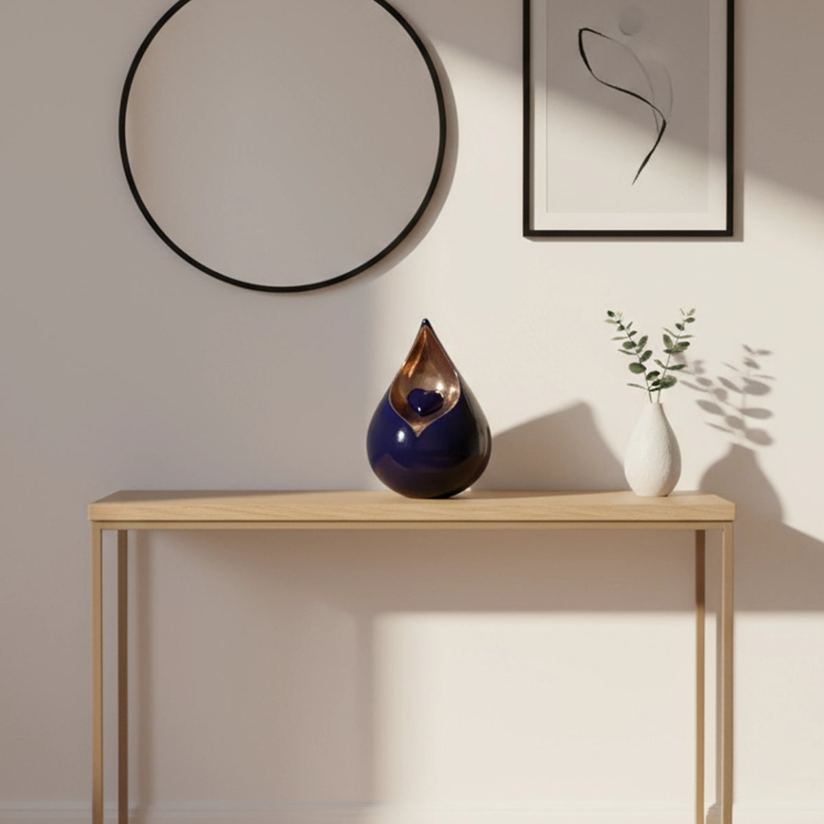 Teardrop Medium Urn with Heart for Ashes in Cobalt Blue and Gold on Wide Table