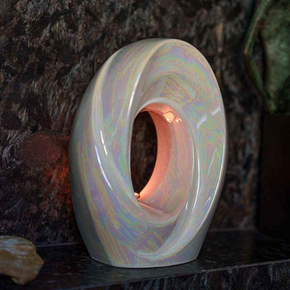 The Passage Adult Cremation Urn for Ashes in Pearlescent White on Shelf Left