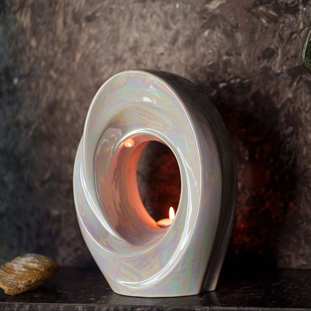 The Passage Adult Cremation Urn for Ashes in Pearlescent White on Shelf Up Front