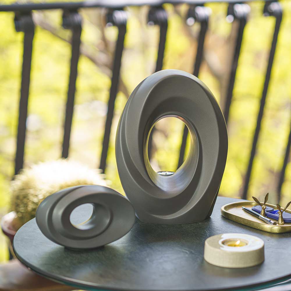 The Passage Cremation Urn for Ashes Matte Grey with Ashes Keepsake Outside on Table Light