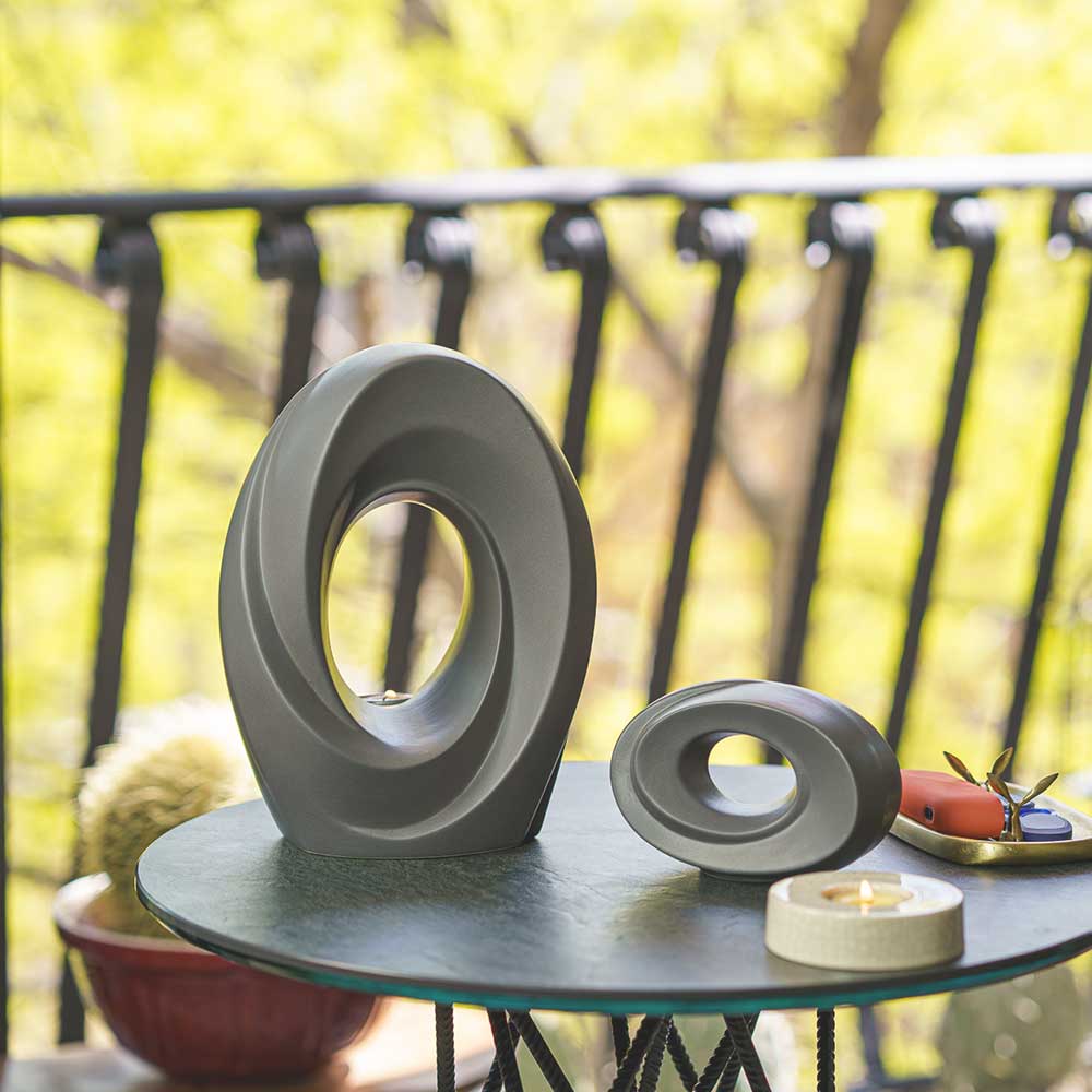 The Passage Cremation Urn for Ashes Matte Grey with Ashes Keepsake Outside on Table