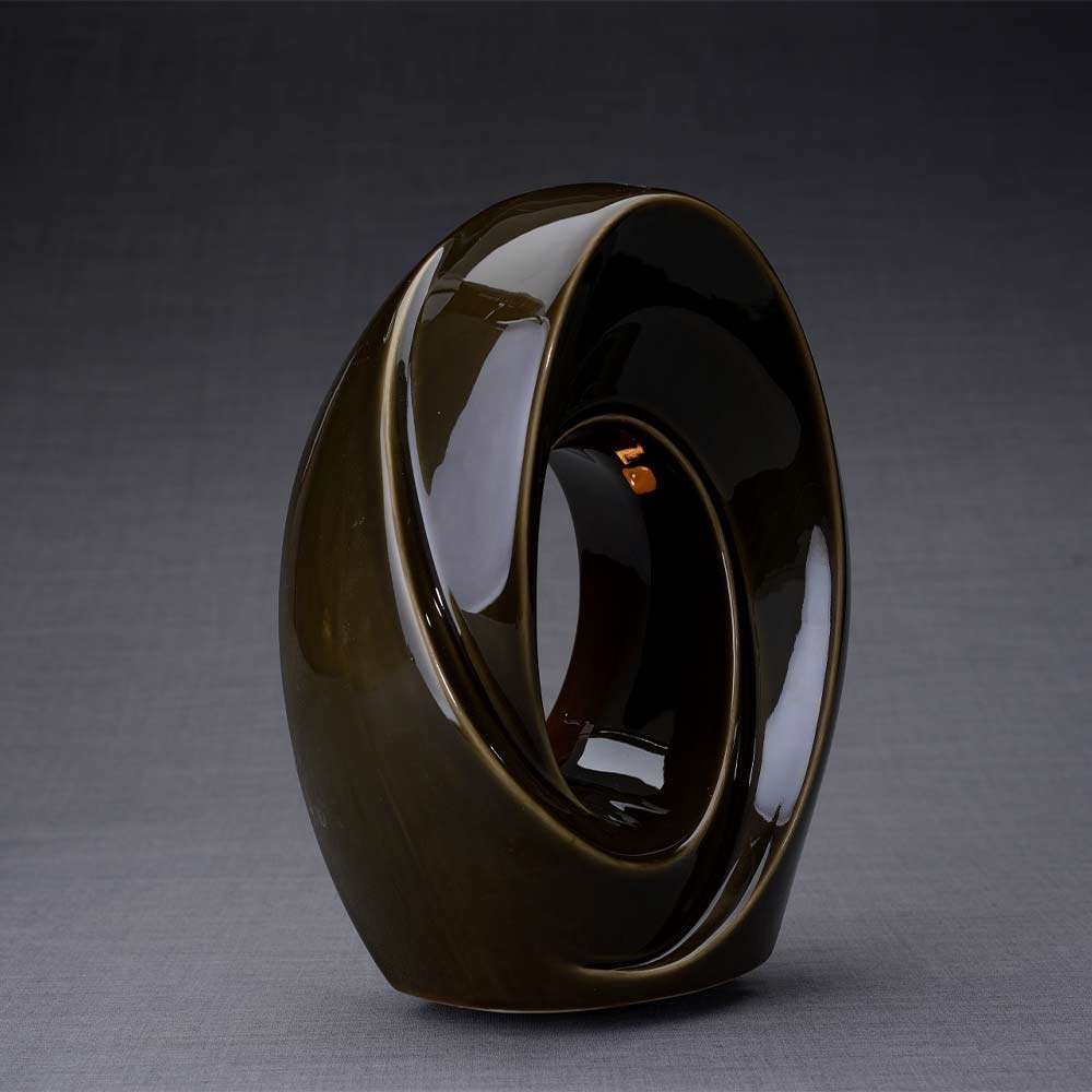 The Passage Cremation Urn for Ashes in Oily Brown Facing Right Dark Background