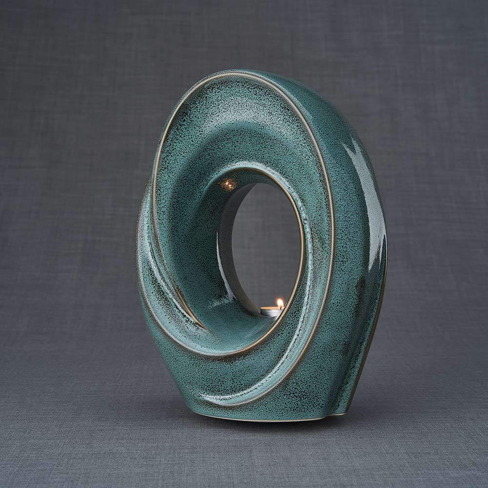 The Passage Cremation Urn for Ashes in Oily Green Turned Left Dark Background