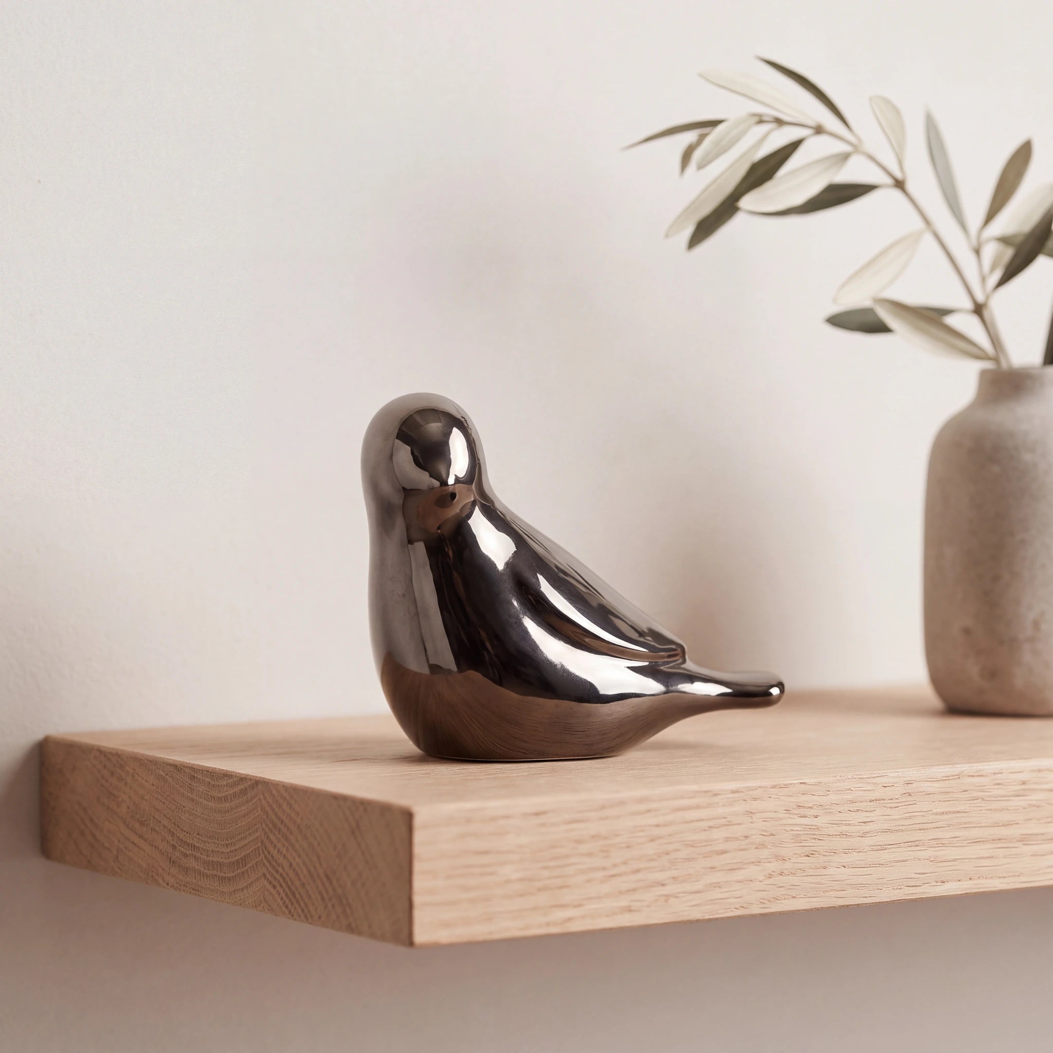 Whistling-Bird-Keepsake-Urn-for-Ashes-in-Graphite-Oak-Shelf