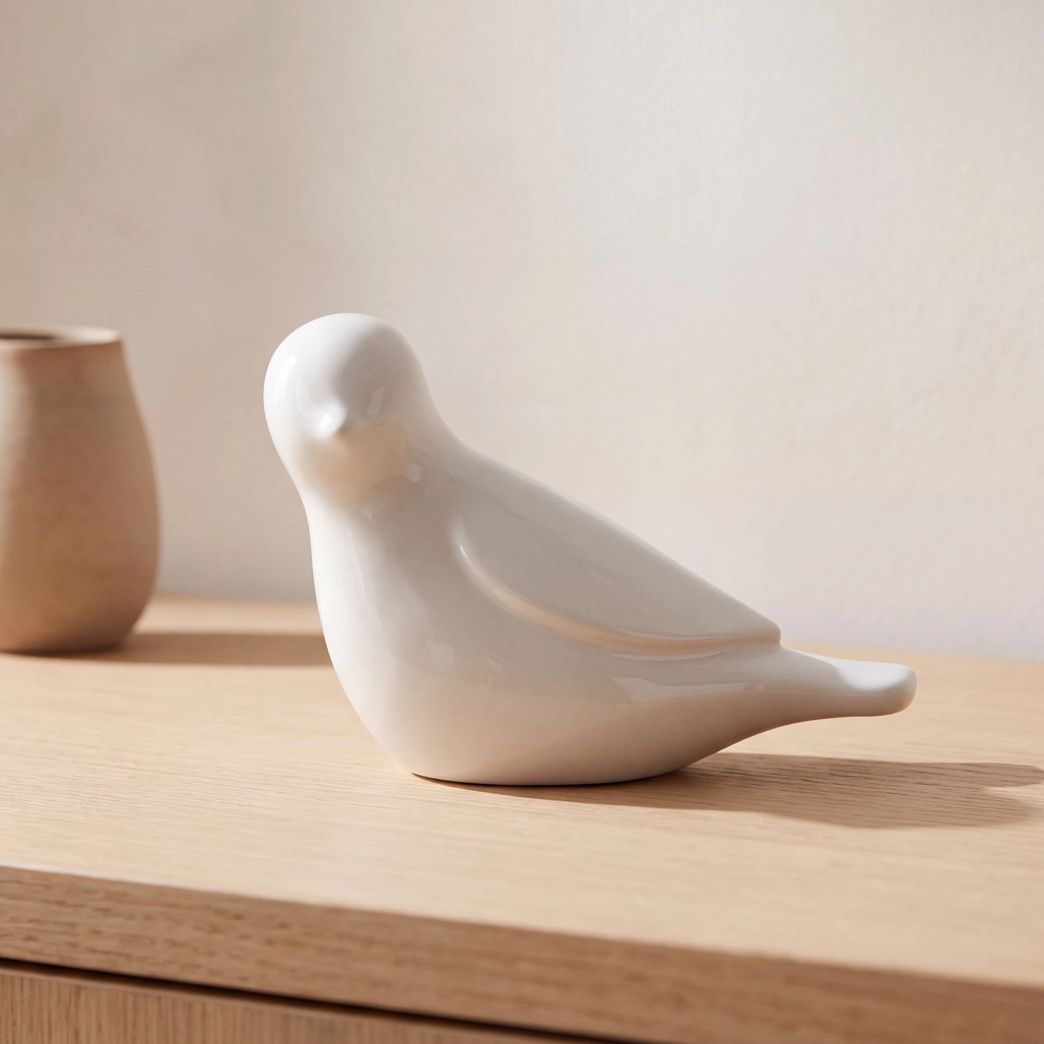 Whistling-Bird-Keepsake-Urn-for-Ashes-in-Sage-White-Oak-Console