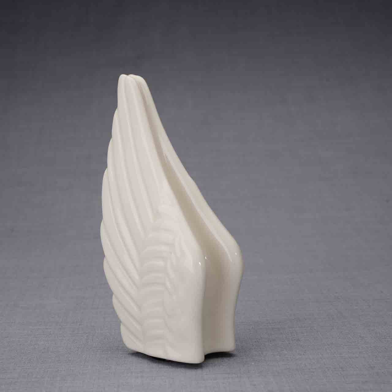Wings Ashes Keepsake Urn in Cream Turned Left Dark Background