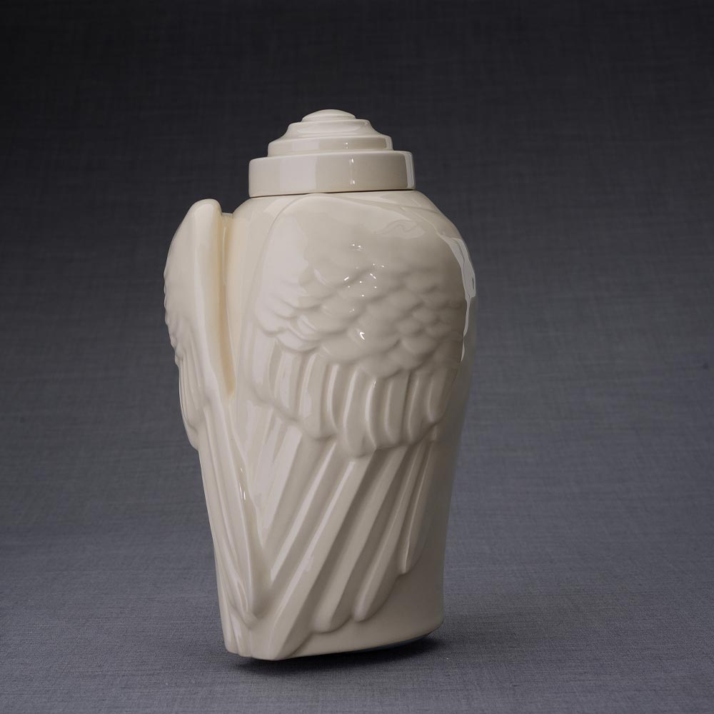 Wings Cremation Urn for Ashes in Cream Turned Left Dark Background