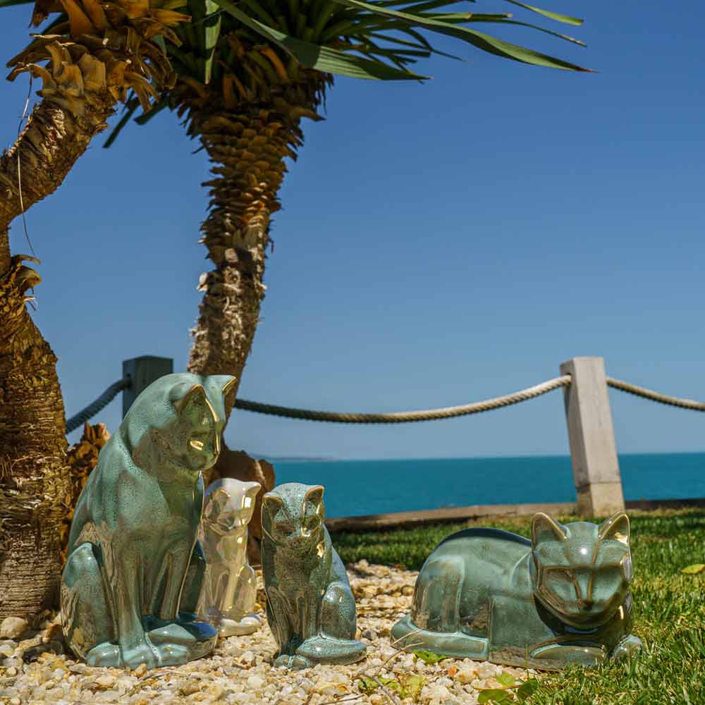 Oily Green Cat Urns For Ashes Outside In The Sun Under A Tree