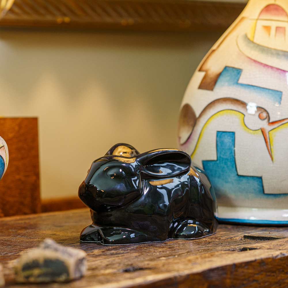 Rabbit Urn For Ashes Glossy Black On Cupboard Front Left