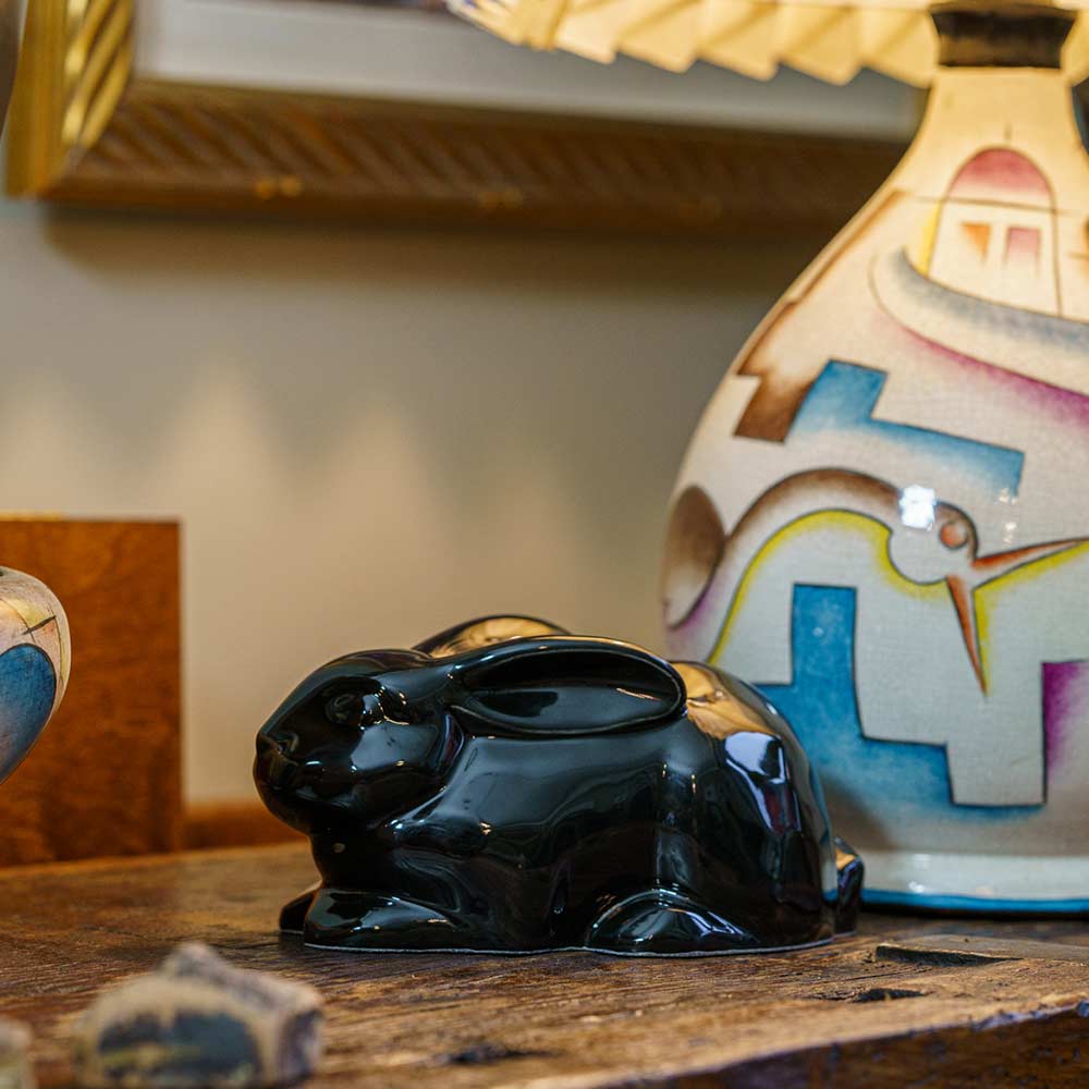 Rabbit Urn For Ashes Glossy Black On Cupboard Left