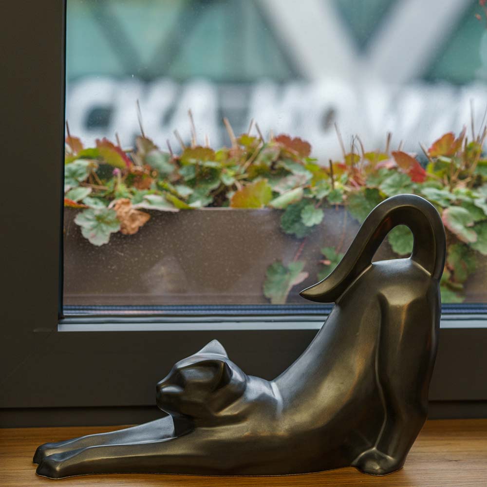 Stretching Cat Urn For Ashes Matte Black On Shelf Left
