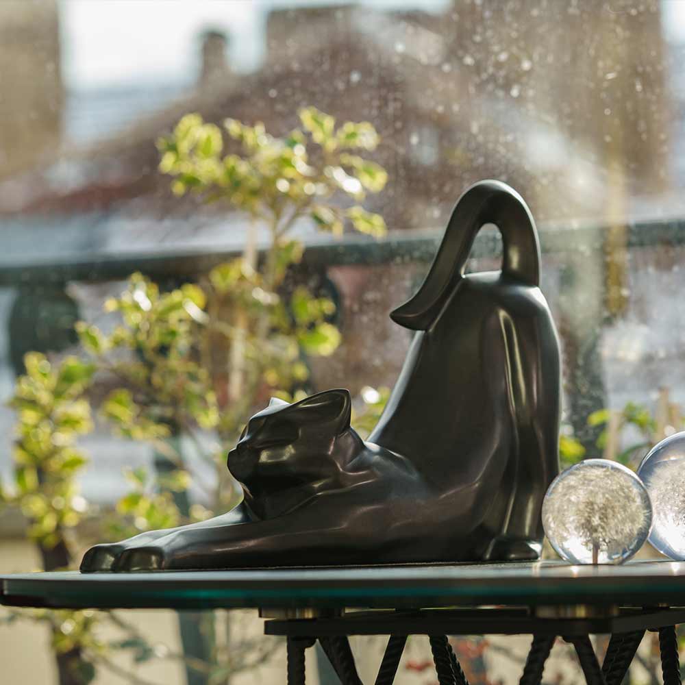 Stretching Cat Urn For Ashes Matte Black On Table Left
