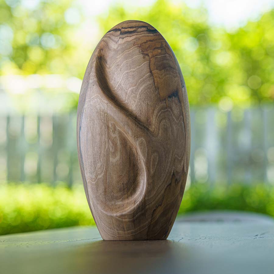 Infinity Wooden Adult Urn for Ashes Walnut Wood on Shelf in Garden