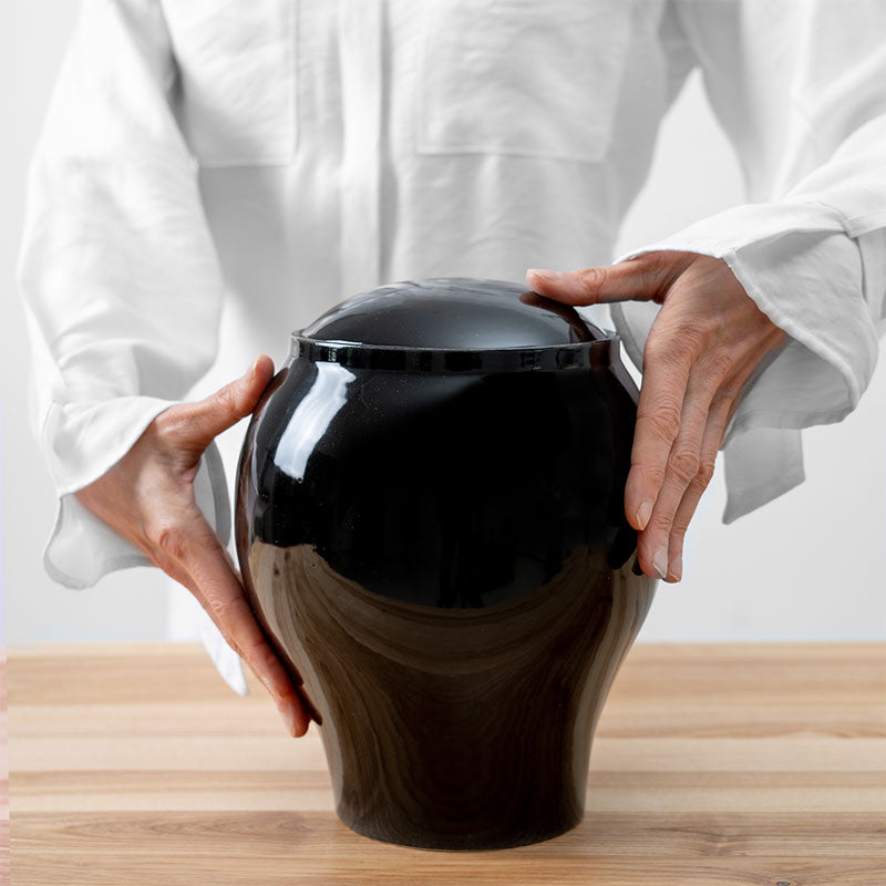 Pure Black Classic Cremation Urn for Ashes Being Held