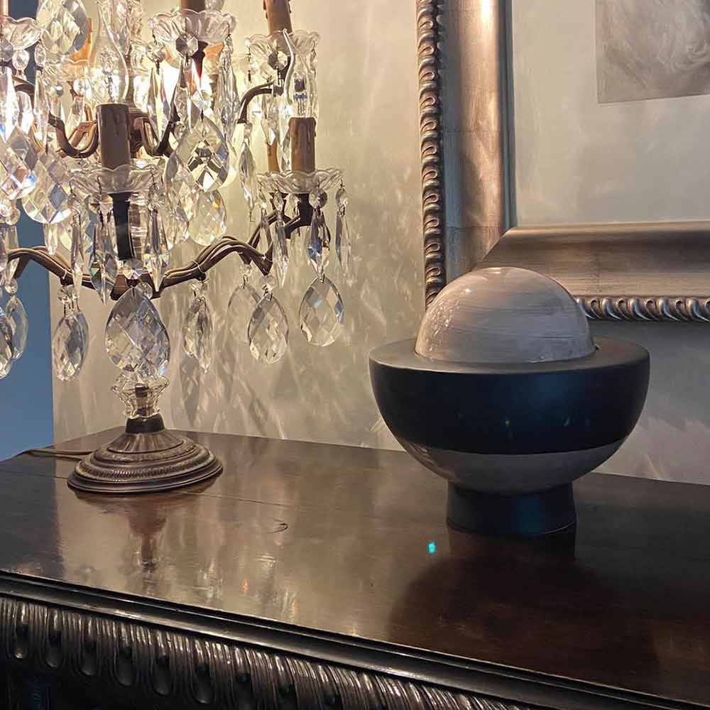 Saturn Cremation Urn For Ashes Next To Lamp