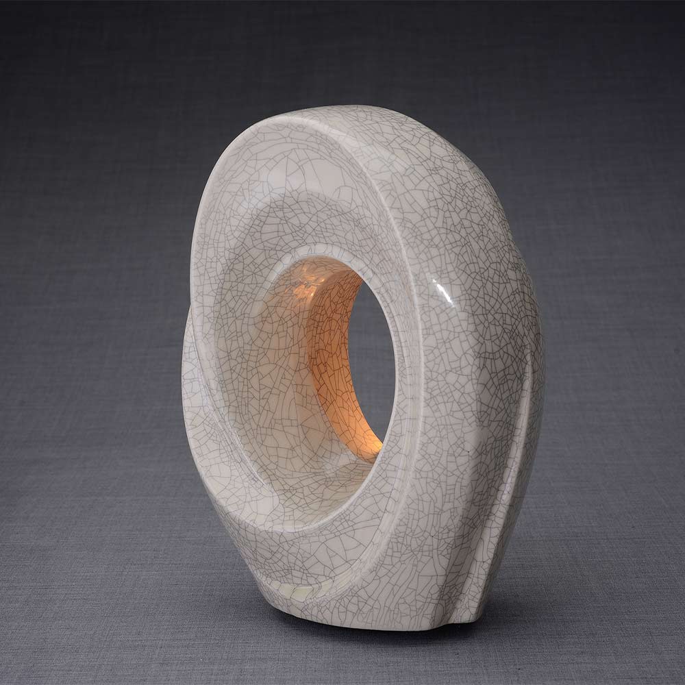 The Passage Cremation Urn for Ashes in Crackle Glaze Facing Left Dark Background