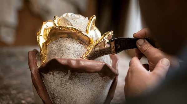 10 wooden urns with gold leaf