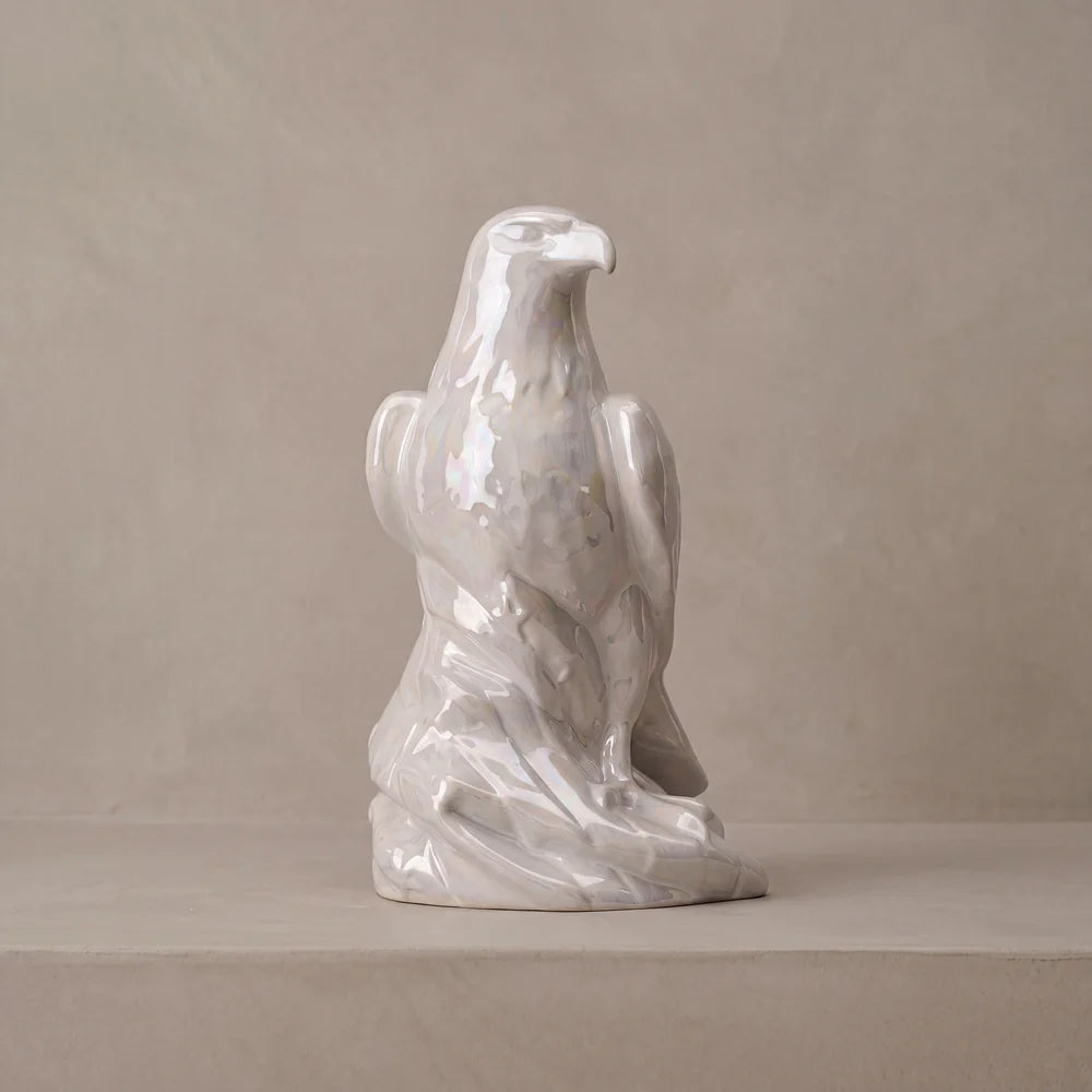 Eagle ceramic urn for adult ashes in pearlescent white on a pale shelf