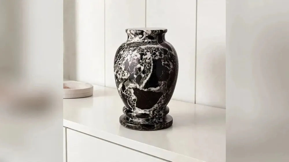 Classic Marble keepsake urn in black and white in a living room