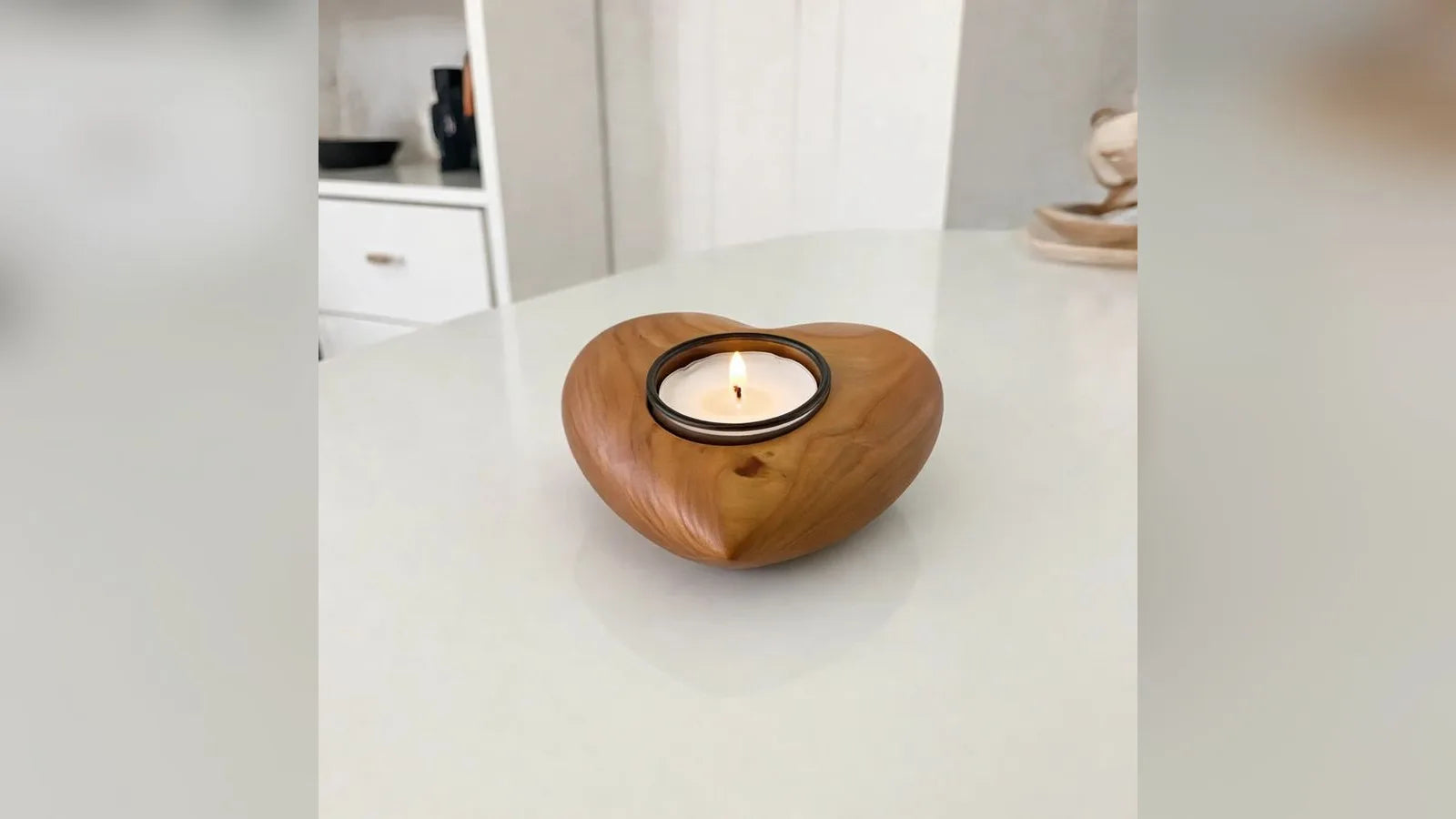 Cherry wood heart candle holder keepsake urn in a living room