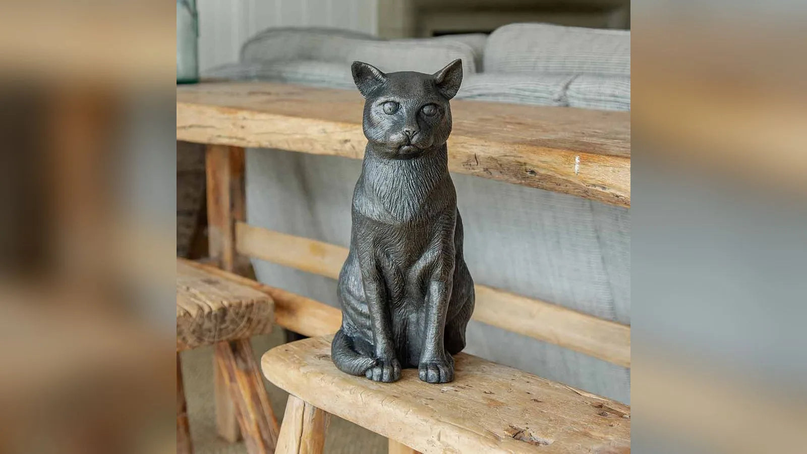 Sitting cat figurine urn for ashes on a bench