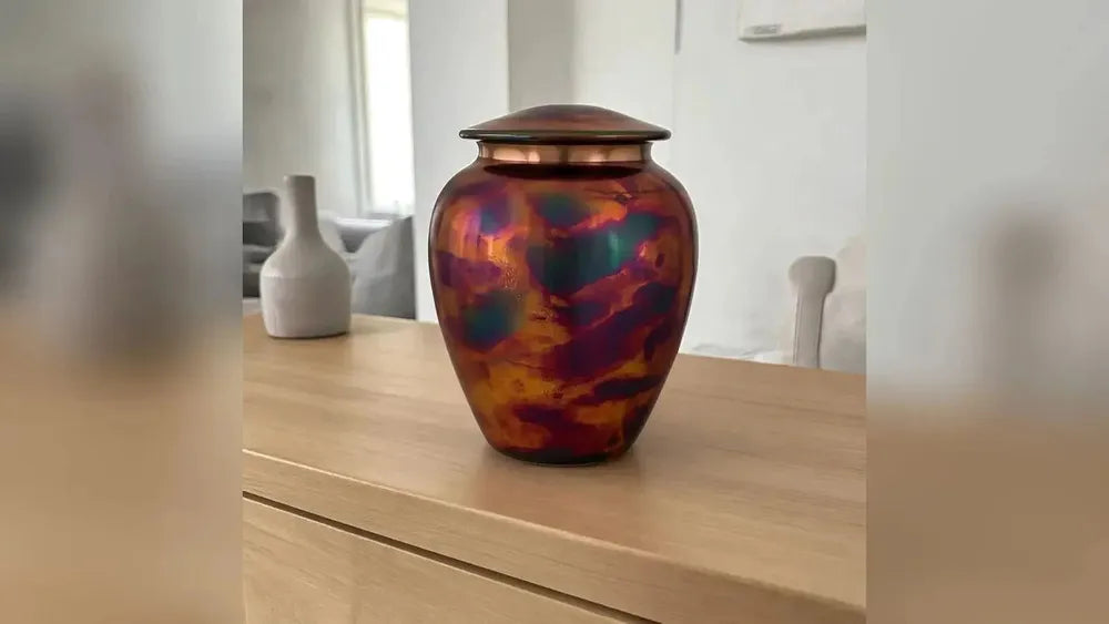 Raku metal keepsake urn in multicolor in a living room