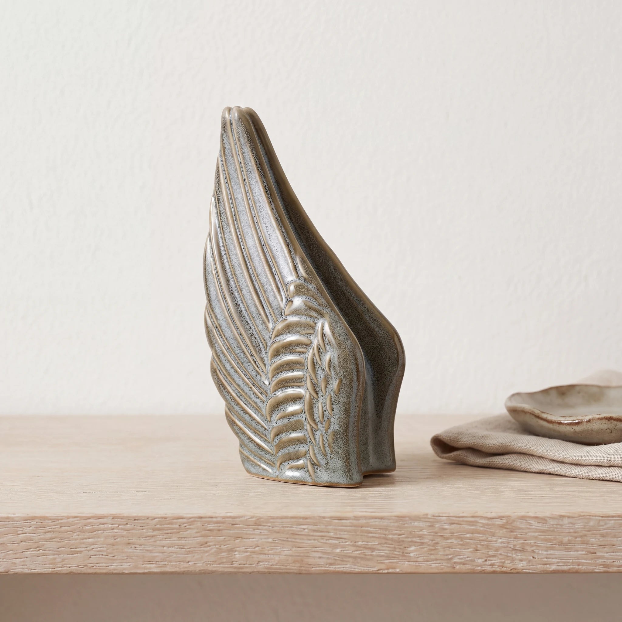 Angel-Wings-Small-Urn-for-Ashes-in-Oily-Green-keepsake_folded_napkin