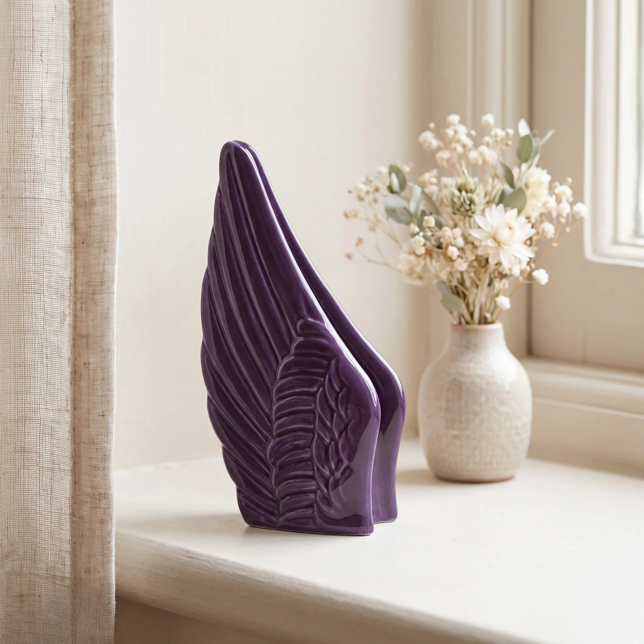 Angel-Wings-Small-Urn-for-Ashes-in-Purple-keepsake_windowsill_posy