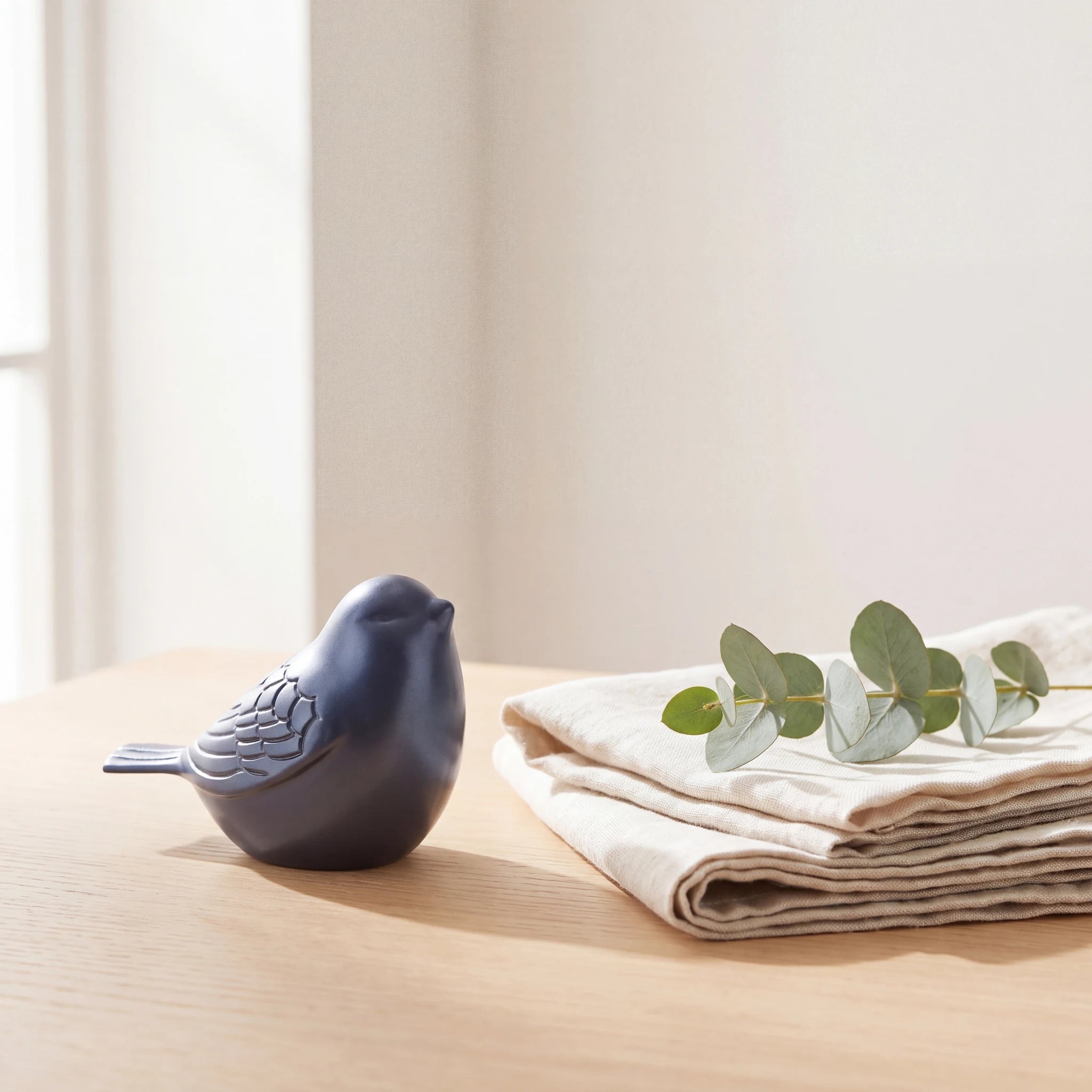 Bird-Keepsake-Urn-for-Ashes-in-Midnight-Blue-Folded-Linen