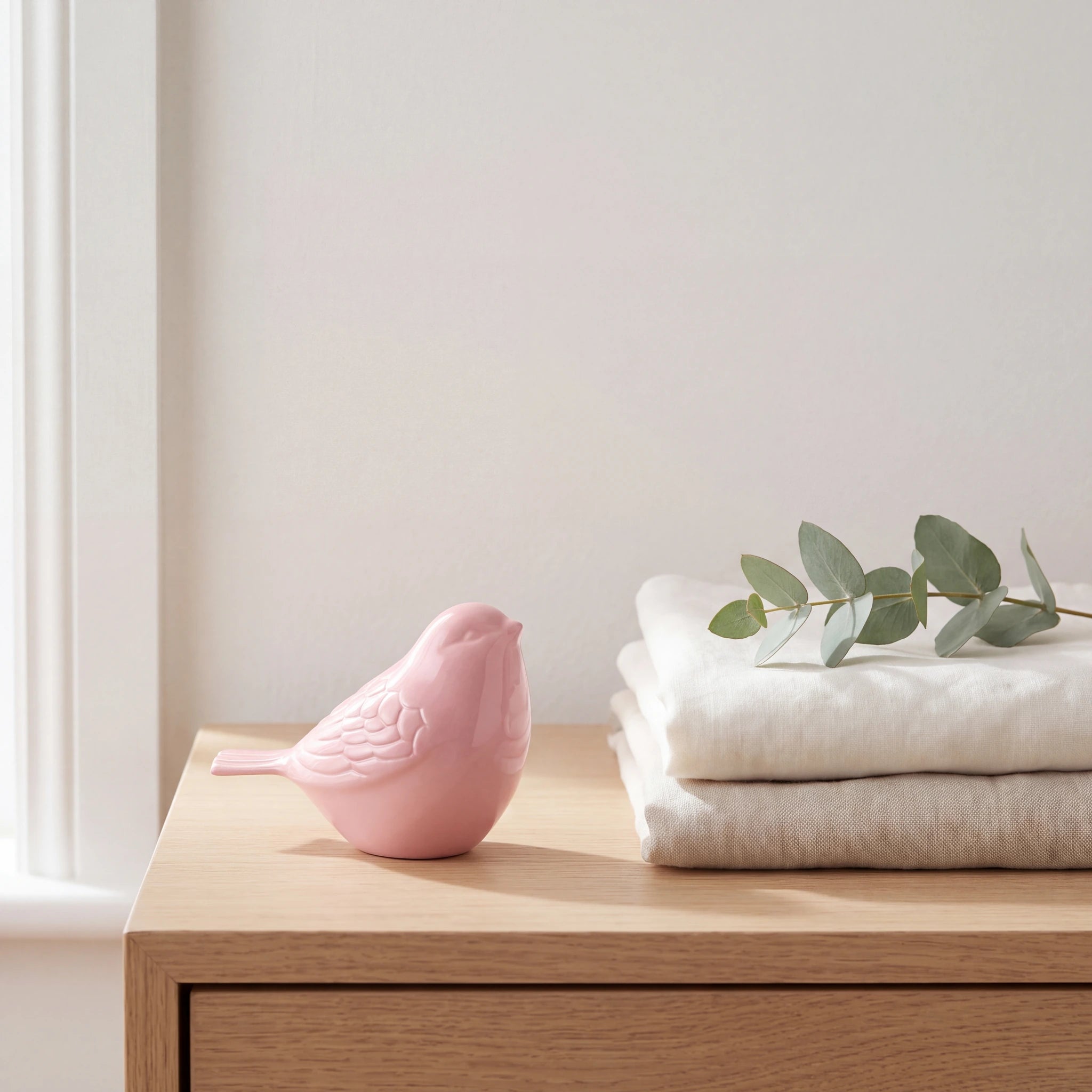 Bird-Keepsake-Urn-for-Ashes-in-Pink-Folded-Linen