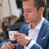 Braided Leather Ashes Bracelet for Men on Wrist Drinking Coffee