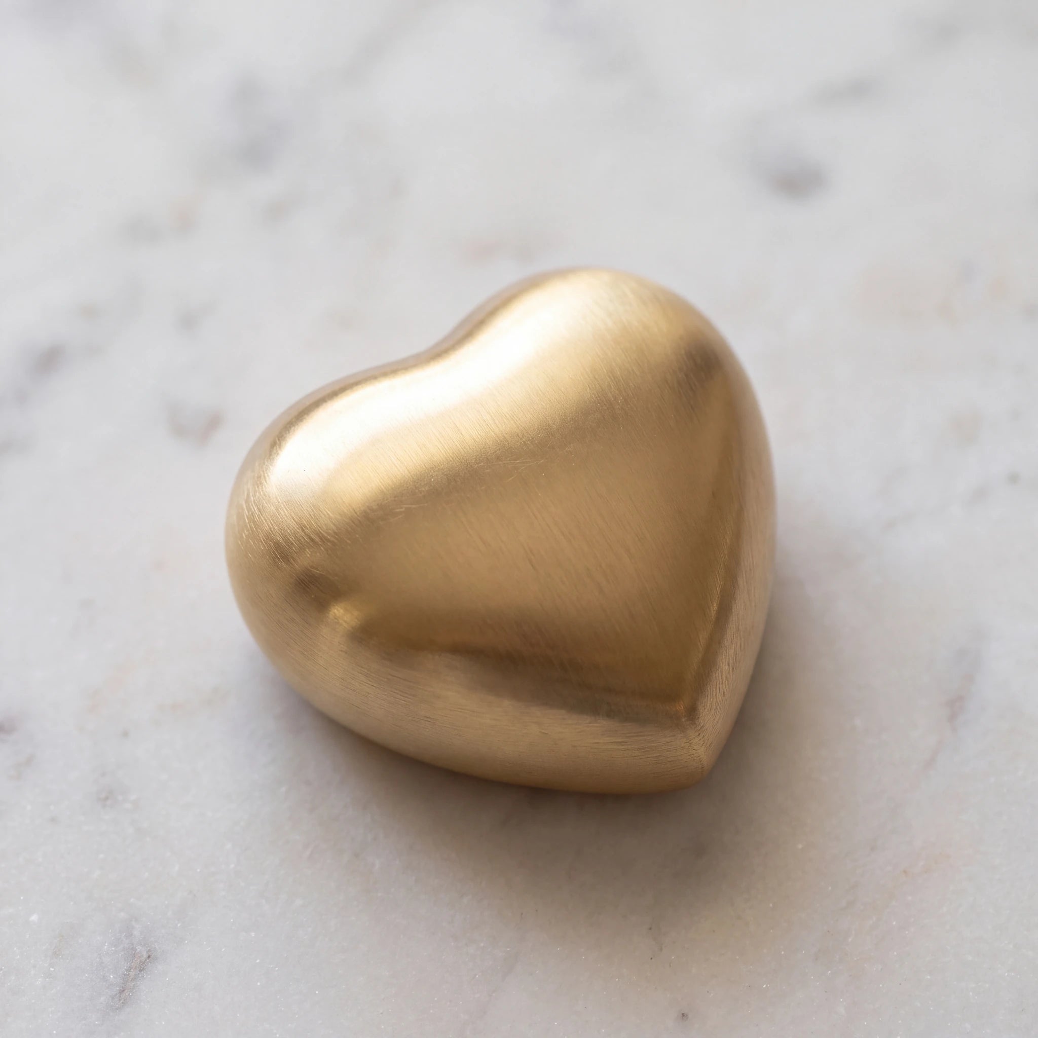Brushed-Metal-Heart-Keepsake-Urn-for-Ashes-in-Gold-On-Marble